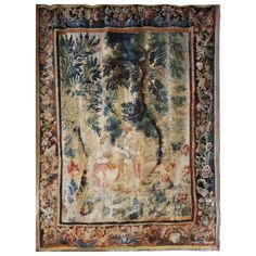 an antique tapestry with animals and trees on it