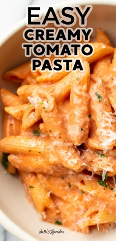 a bowl filled with pasta covered in sauce and parmesan cheese on the side