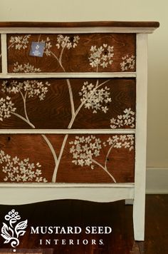 an old dresser with flowers painted on it