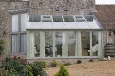 a stone building with a glass roof and windows