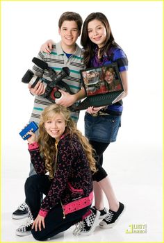 two girls and a boy are posing for the camera