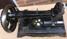 an old sewing machine with flowers on it