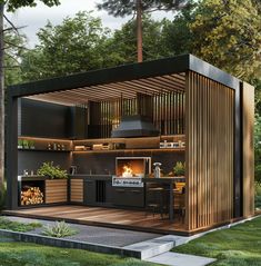 an outdoor kitchen is built into the side of a tree - lined area with grass and trees