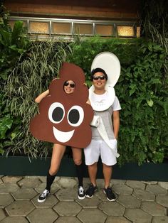 two people standing next to each other in costumes