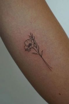 a single flower tattoo on the arm