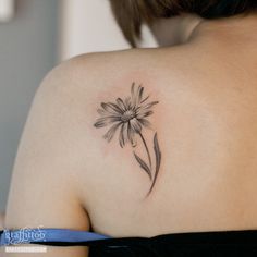 a woman with a flower tattoo on her shoulder