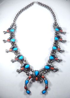 VINTAGE STERLING SILVER HAND MADE NATIVE AMERICAN TURQUOISE & CORAL 24" SQUASH BLOSSOM NECKLACE ... NAJA IS 2.25" TALL and 2.5" WIDE .....HAS TEN BLOSSOMS 1.75" x 1" ......HAS 8.5mm SEAM BEADS.....ALL HAND MADE AND WEIGHS 124.1gms..........A TRULY WORK OF ART........VERY NICE!!!!!........FAST & FREE SHIPPING. Native American Turquoise, Squash Blossom Necklace, American Turquoise, Squash Blossom, Coral Turquoise, Vintage Sterling Silver, Native American, Jewelry Watches, Blossom