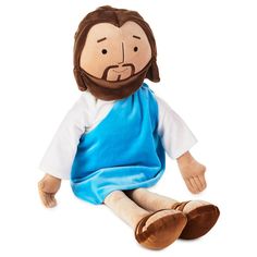 a stuffed jesus doll sitting on the ground