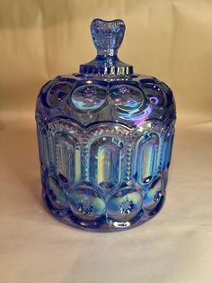 a blue glass jar sitting on top of a table