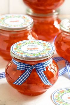 jars filled with jam sitting on top of a table