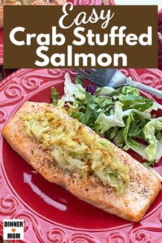 a red plate topped with a sandwich and salad