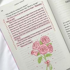 an open book with pink roses on it and the words in english are handwritten