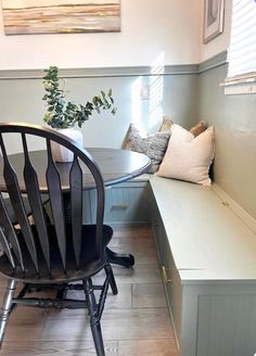 a dining room table and bench in front of a window