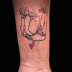 a woman's foot with a tattoo on it that has two people holding hands