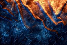 an orange and blue abstract background with some water in it's center, as well as the bottom part of the image