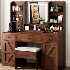 a wooden desk with a mirror above it and shelves on the wall next to it