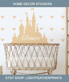 a baby crib in front of a disney castle wall decal