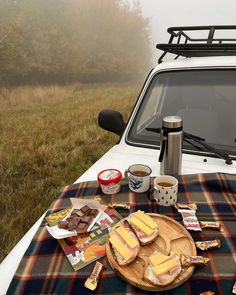 a picnic table is set up on the back of a truck with food and drinks