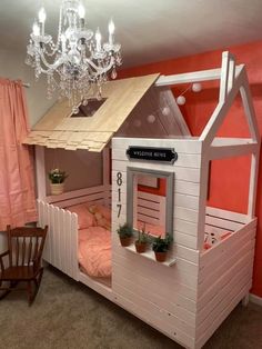 a child's bedroom with a bunk bed made out of pallet boards and a chandelier hanging from the ceiling