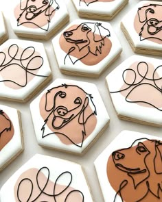 decorated cookies with dogs drawn on them sitting on top of a table next to each other