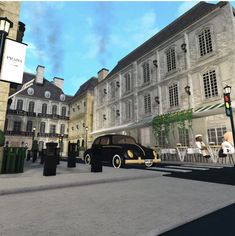 a black car parked in front of a building next to a traffic light and people sitting at tables