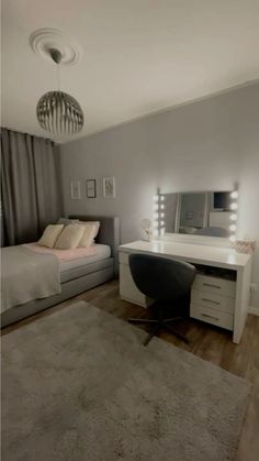 a bedroom with a bed, desk and mirror