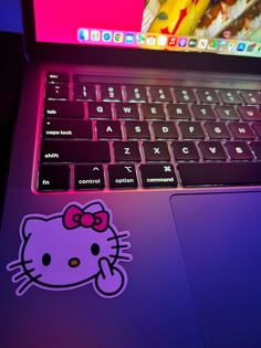 an open laptop computer with a hello kitty sticker on the keyboard