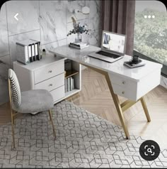 a white desk with a laptop computer on top of it next to a chair and bookshelf