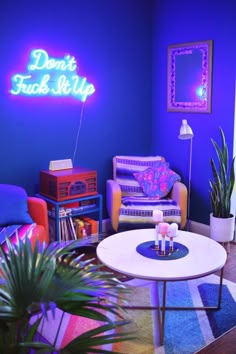 a living room filled with furniture and a neon sign