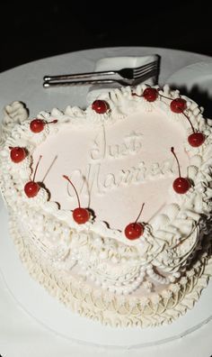 a heart shaped cake with cherries on it