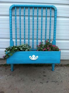 a blue bed frame with flowers in it