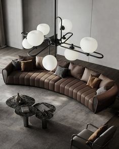 a living room filled with lots of furniture next to a wall mounted light above a table