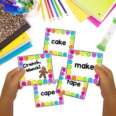 hands holding up cards with words that spell out the word cake and cupcake on them