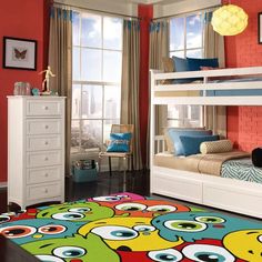 a child's bedroom with two bunk beds and a rug on the floor in front of windows