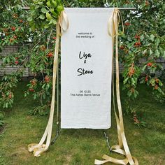 a wedding sign with ribbon tied around it