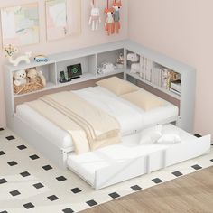 a white bed sitting in a bedroom next to a wall mounted book shelf with stuffed animals on it