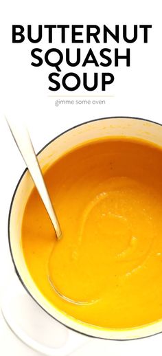 a bowl of butternut squash soup with a spoon in it