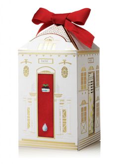 a small white box with a red bow on it's top and the door is open