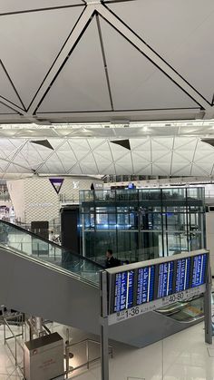 an escalator in the middle of a building with lots of glass and metal