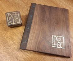 a wooden box sitting on top of a table next to a pair of rubber stamps