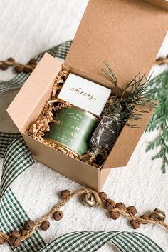 an open box with a candle and some cookies