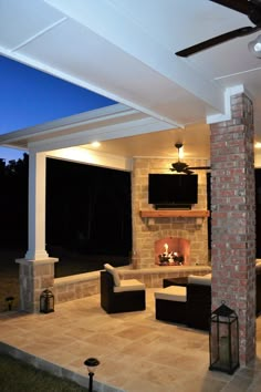 an outdoor living area with fireplace and seating