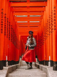 a woman standing in front of an orange structure