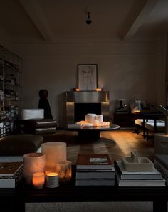 a living room filled with furniture and lit candles