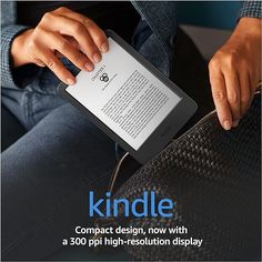 a person holding a kindle on their lap with the cover pulled down and texting it