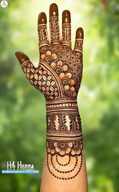 the hand is decorated with henna on it and has intricate designs, such as flowers