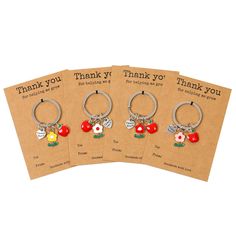 four thank you key chains with charms on them