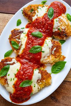 some ravioli with sauce and cheese on a white plate