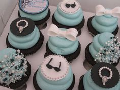 there are many cupcakes that have blue frosting and black icing on them