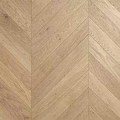 an image of wood flooring that looks like chevroned herringbones in natural colors